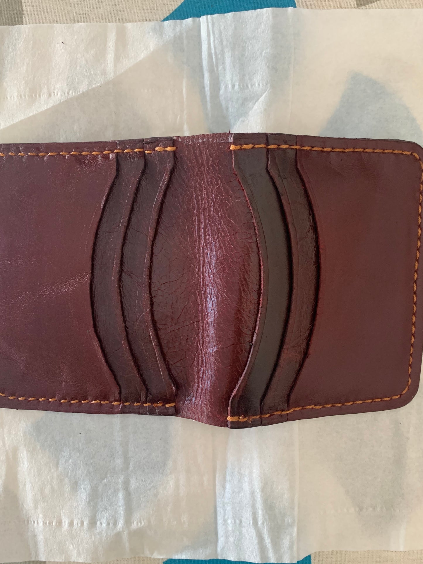 Dark brown and red leather bifold wallet