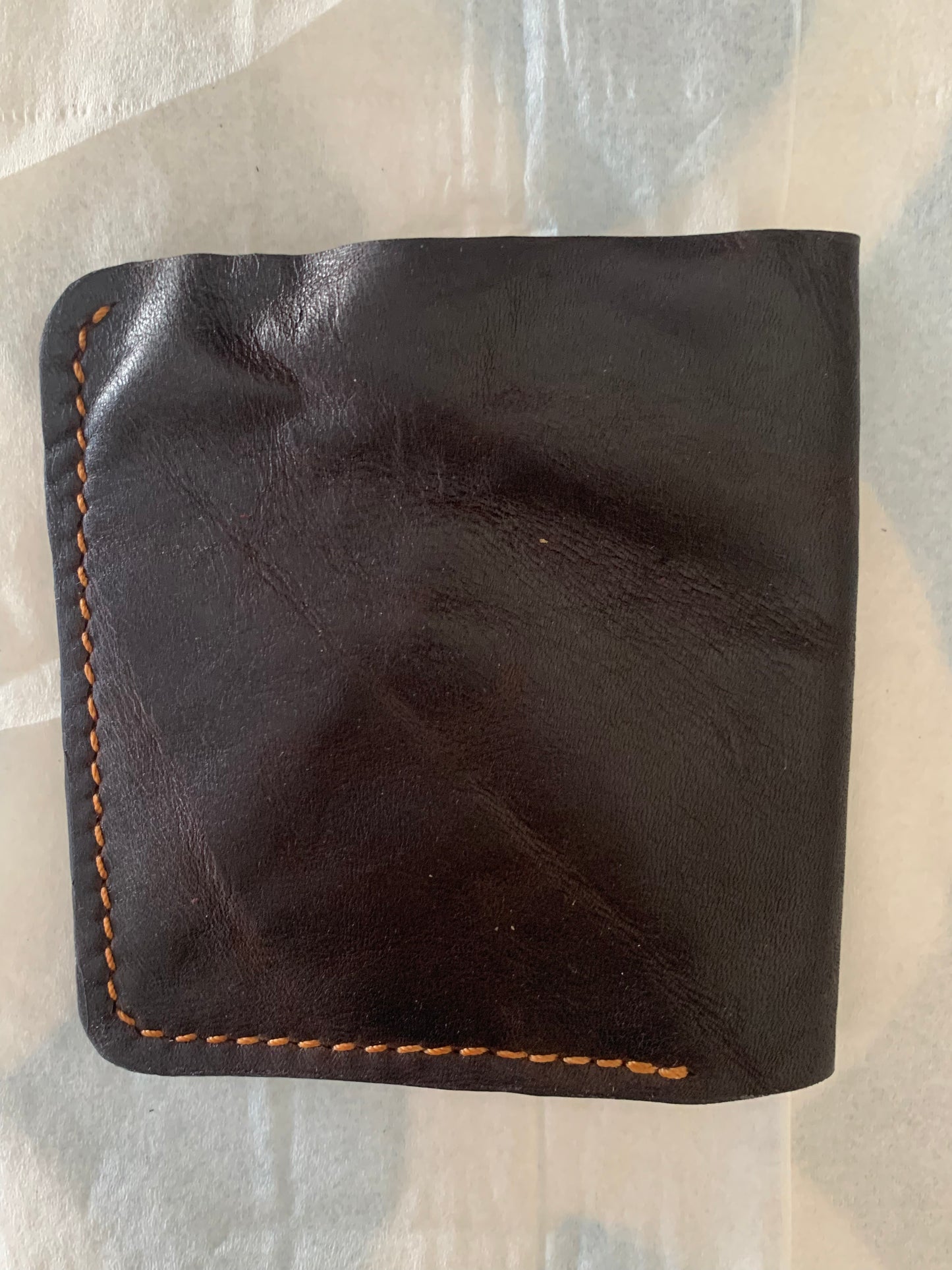 Dark brown and red leather bifold wallet