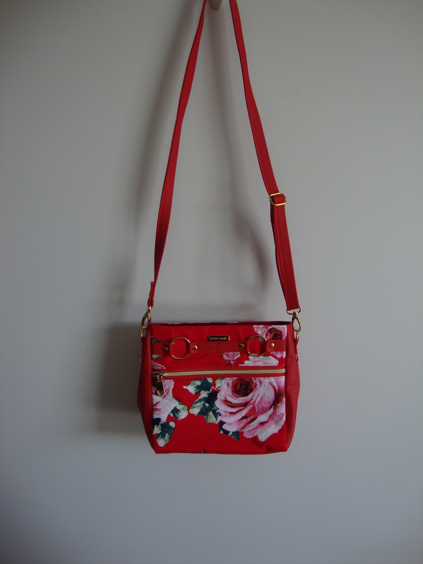 red and pink roses with red vinyl crossbody bag