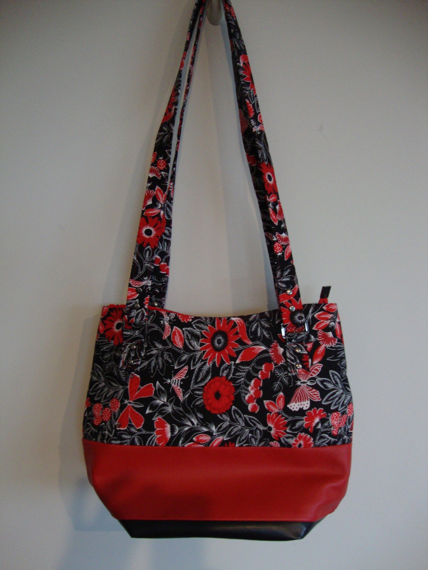 Red flower with black background with Red and Black Vinyl Tote Bag